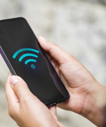 close-up-phone-hands-with-wifi-symbol.jpg